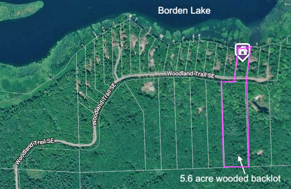 1 acre lake lot with additional 5.6 acres across Woodland Trail