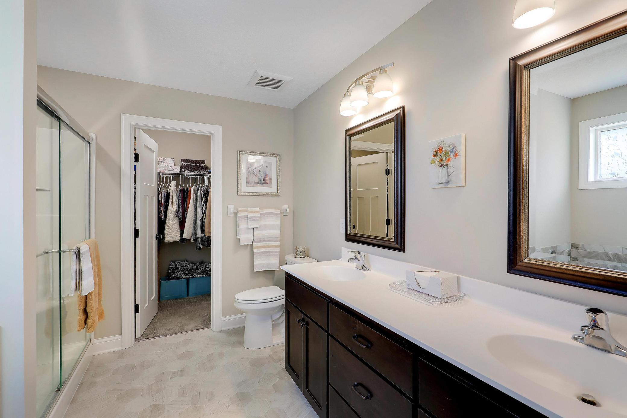 Roomy primary bath has a dual vanity, soaker tub, and separate shower