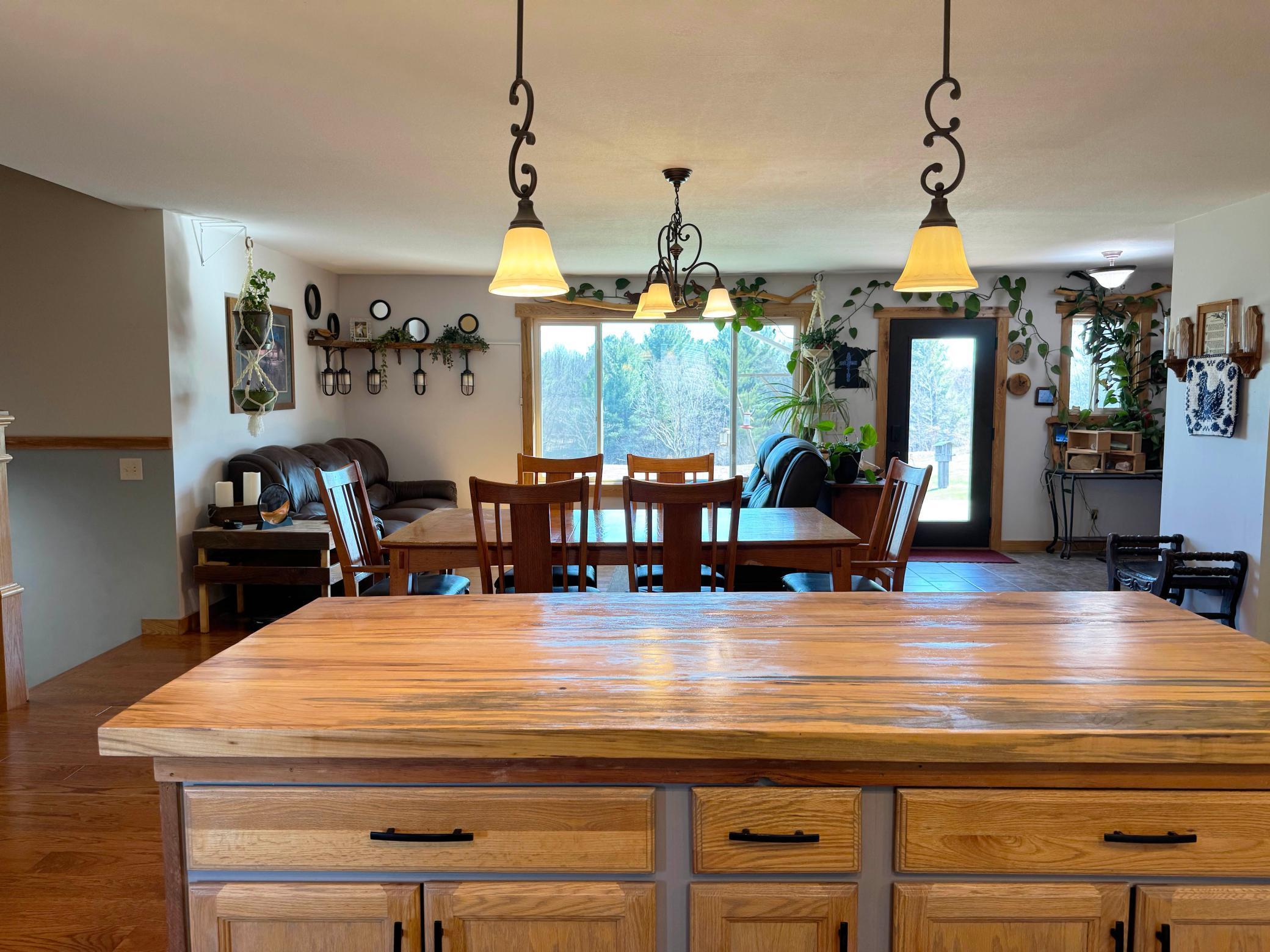 Looking over the kitchen island to the dining room and living room beyond.