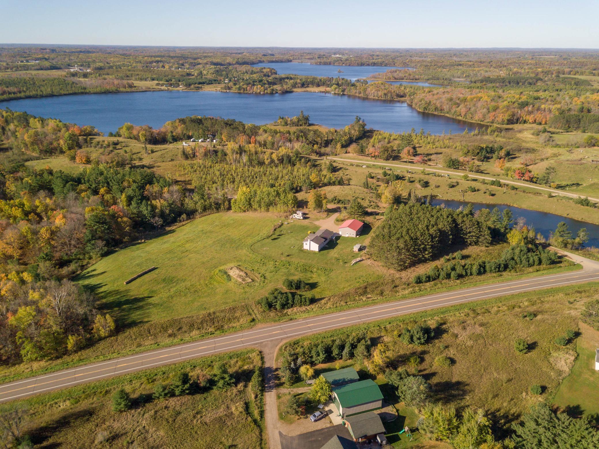 Aerial views of the property with beautiful lake scenery in the horizon.