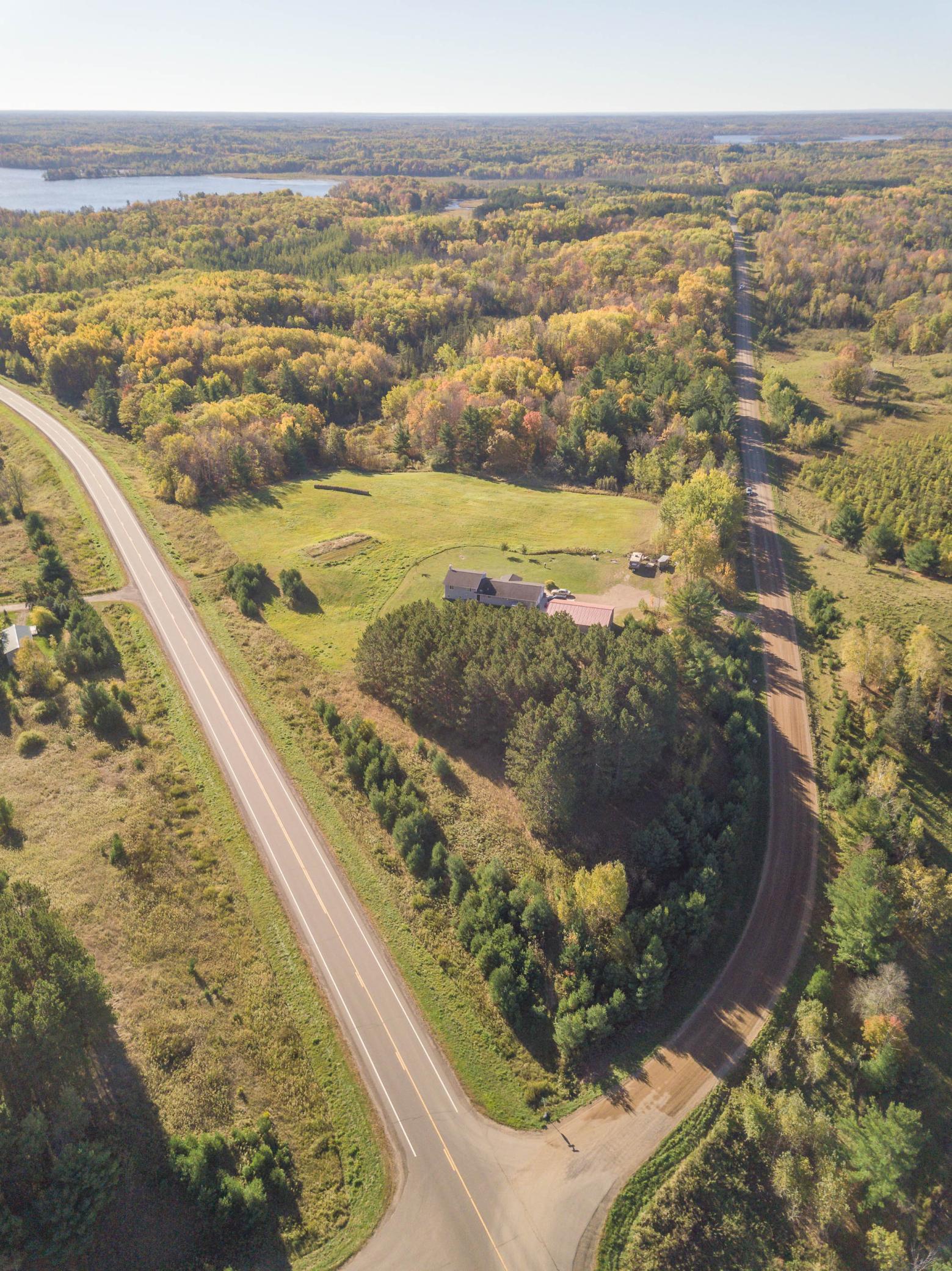 An aerial view of the property situated at the junction of the county and township roads. At this location, there are dozens of area lakes to enjoy at your fingertips, but then you can come home to enjoy your private nature haven!