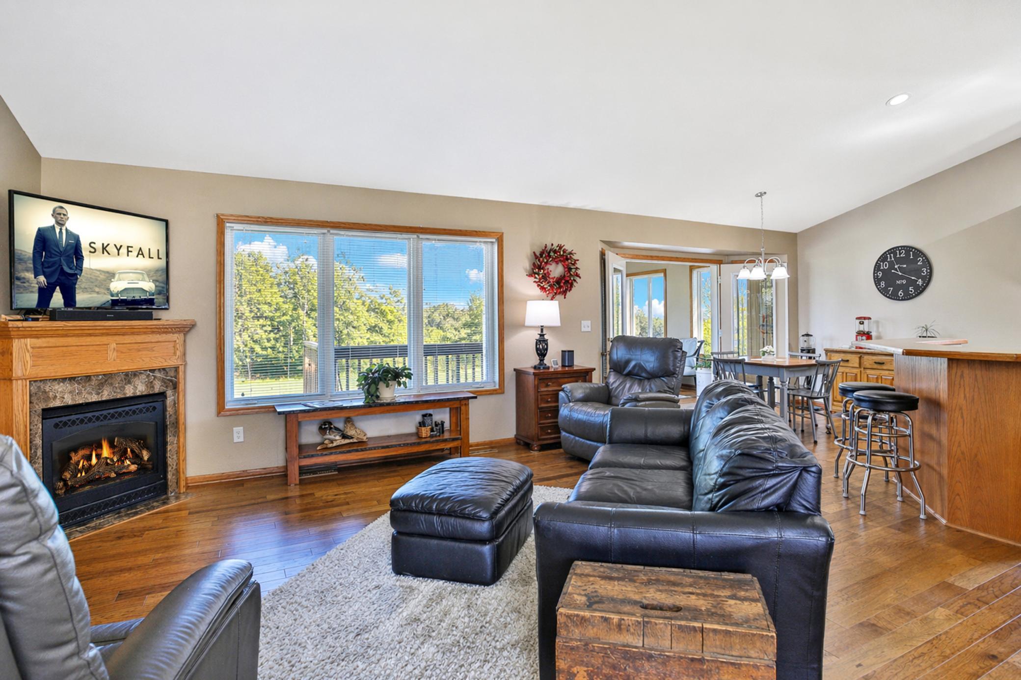 Living room with picture window and gas fireplace