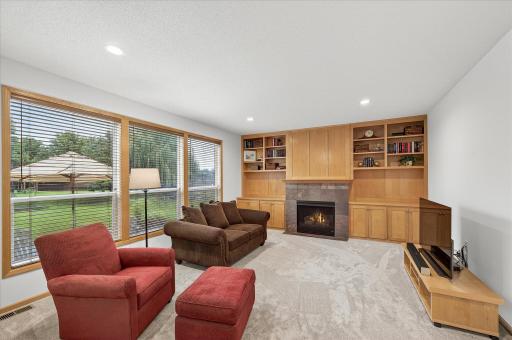 The living room features a cozy fireplace with built-ins and generous natural light.