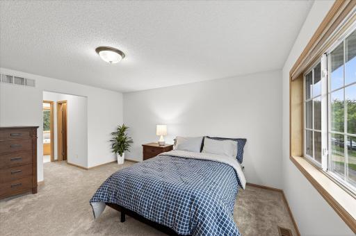 The primary suite features two closets and a full bathroom with dual sinks, a separate tub, and shower.