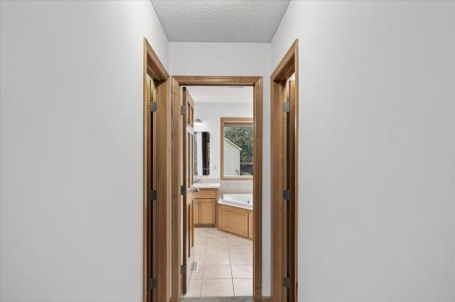 The primary suite features two closets and a full bathroom with dual sinks, a separate tub, and shower.