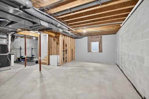 The unfinished lower level offers storage or future living space.