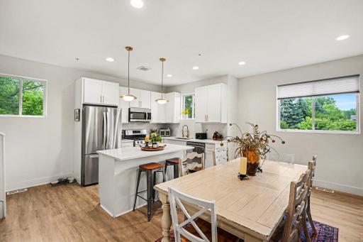 Beautiful gold drop lights over the island as well as recessed lighting throughout the main level.
