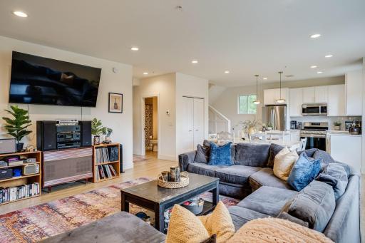 Photo from the living room showing the open concept main level. Access to the bedroom, 3/4 bath and access to the balcony on the left.