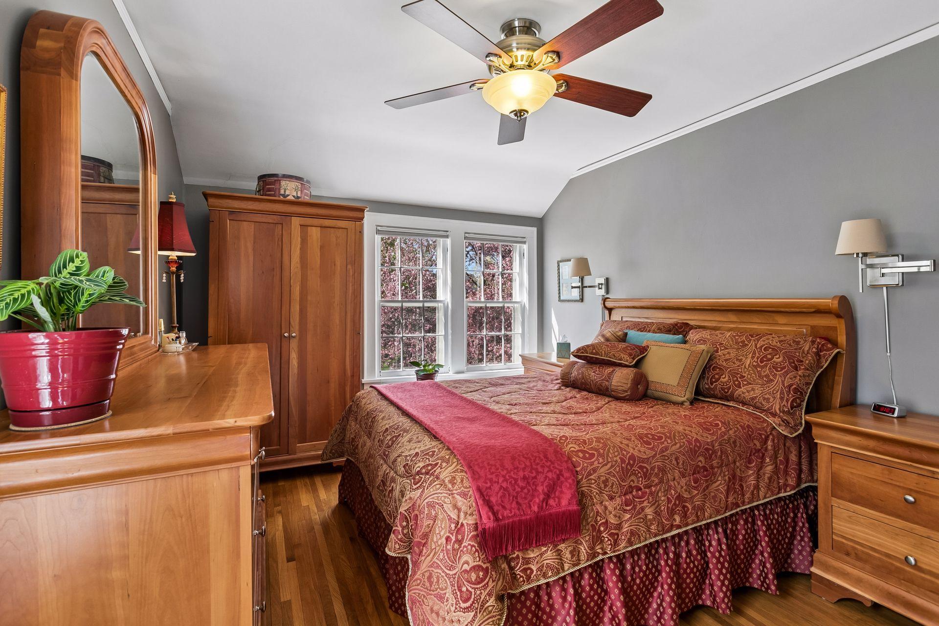 Upper-level primary bedroom with hardwood floors.