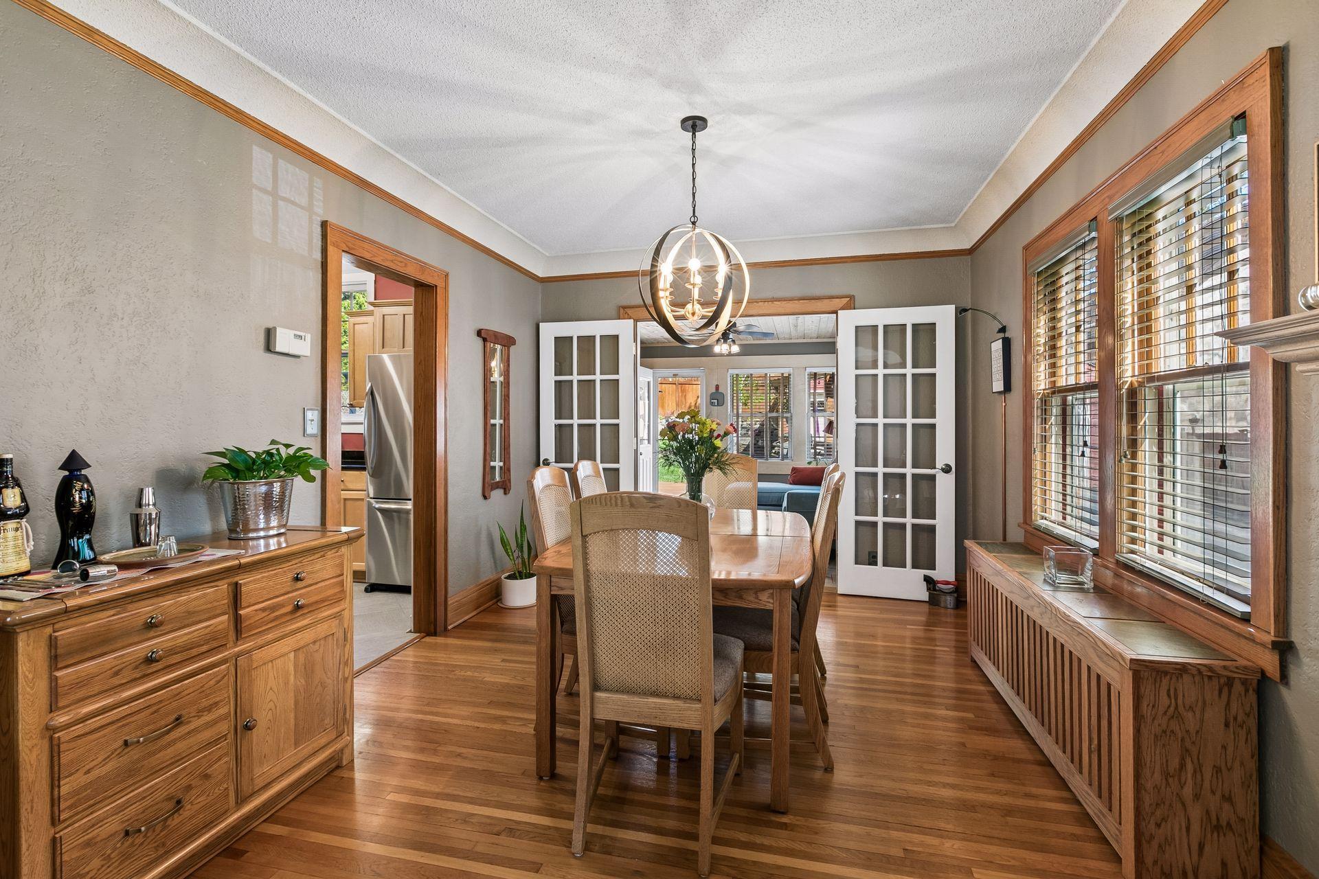 The dining room offers space to extend for gatherings and features a custom-built wood radiator cover that doubles as a buffet.
