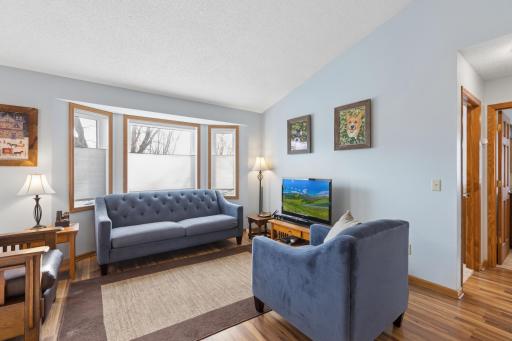 The upper level living room is inviting and cozy! Warm paint colors, gorgeous flooring and large windows make this room a dream!