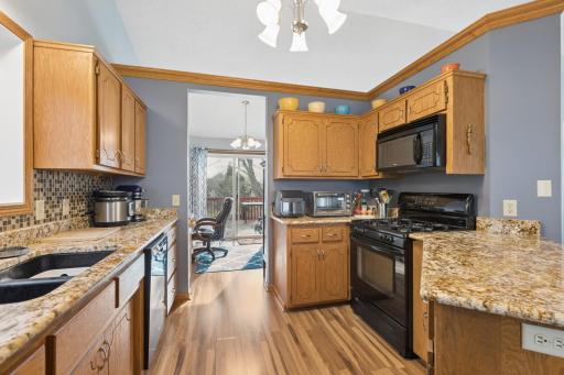 Granite countertops, black appliances, and the beautiful wood floors make the kitchen extra special! Lots of cupboards too!