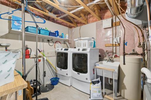 Even the laundry room is nice here! Washer and dryer will stay. Great laundry sink and wonderful storage too!