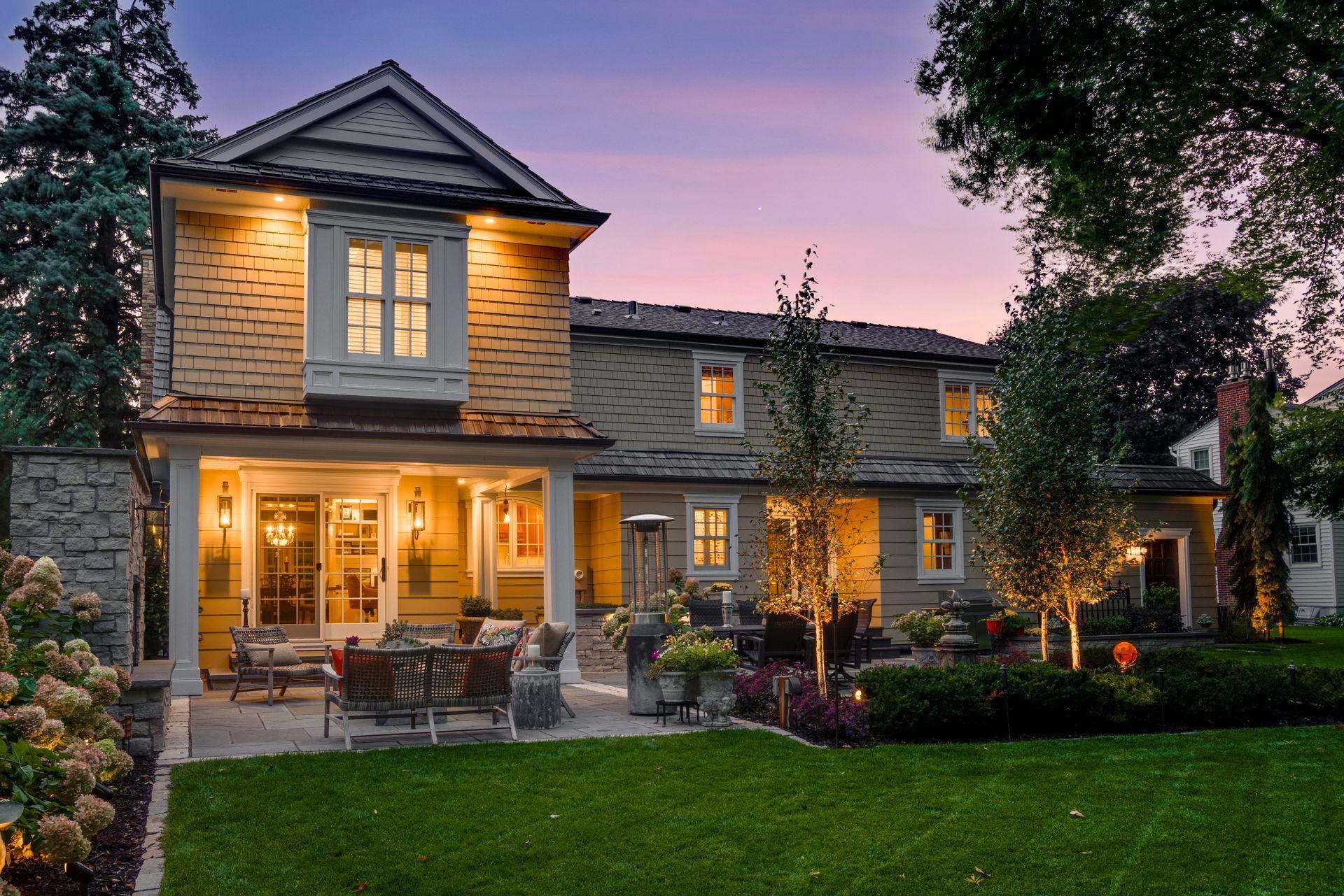 The crafted water fountain and special lighting create a serene ambiance and adds a touch of sophistication to the immaculate landscaped yard.