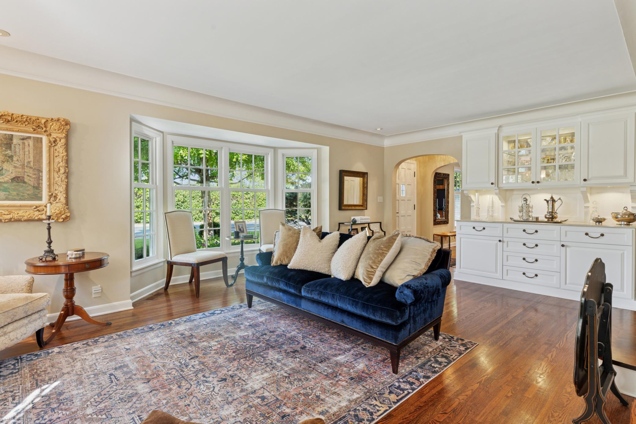 Built-in hutch in living room with large bay windows floor to ceiling