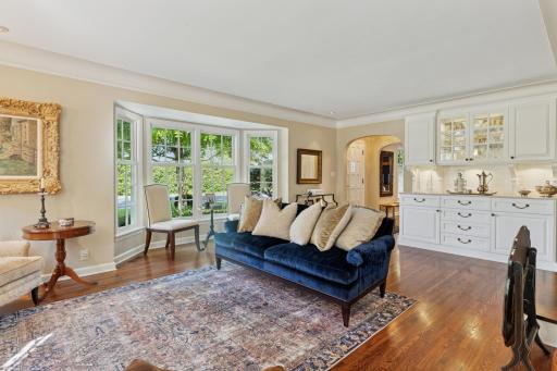 Built-in hutch in living room with large bay windows floor to ceiling