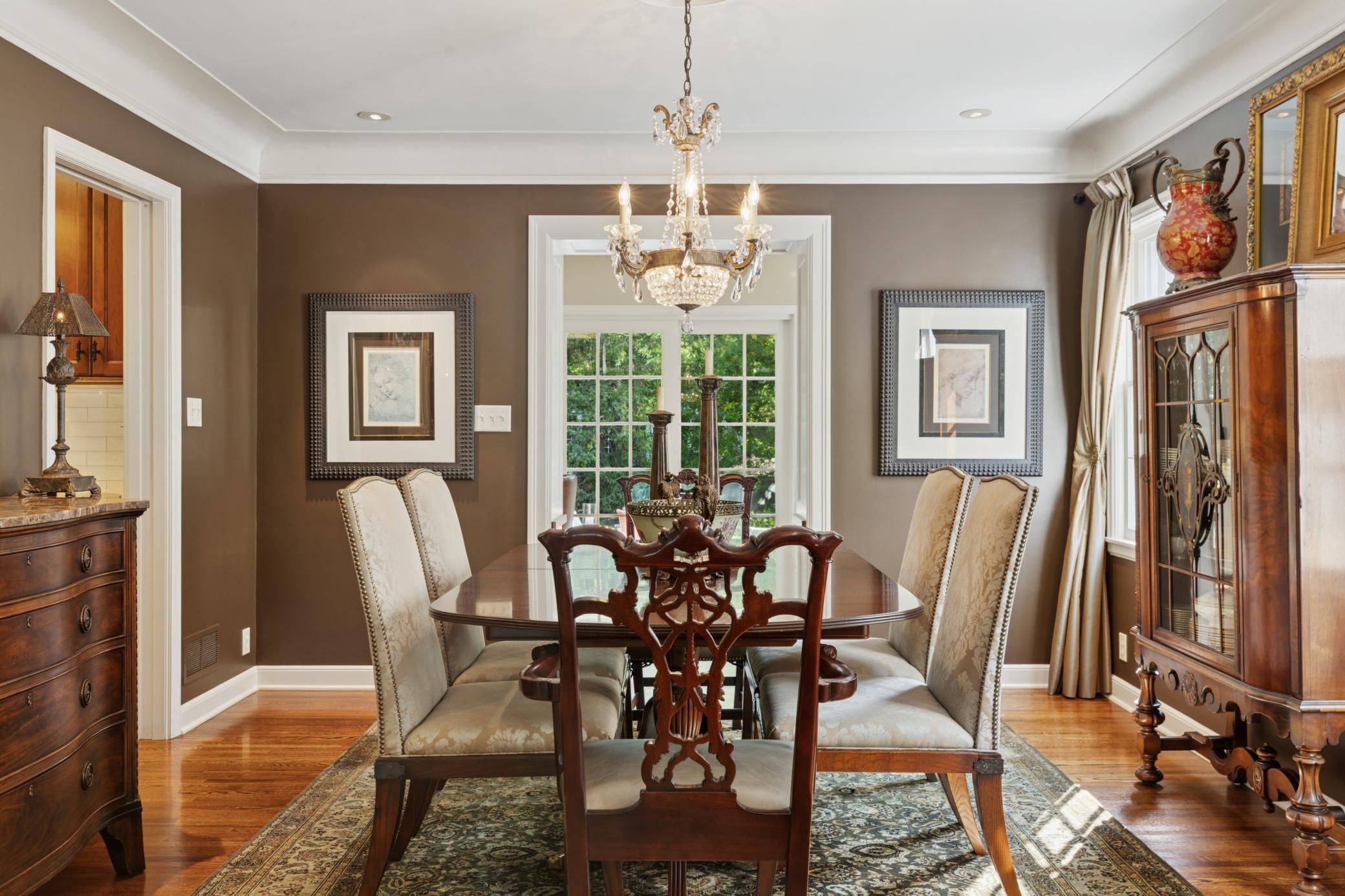 Elegant dining room with coved ceilings and beautiful Schonbeck crystal chandelier