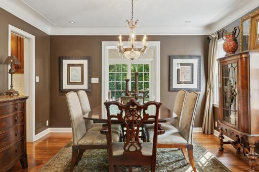 Elegant dining room with coved ceilings and beautiful Schonbeck crystal chandelier