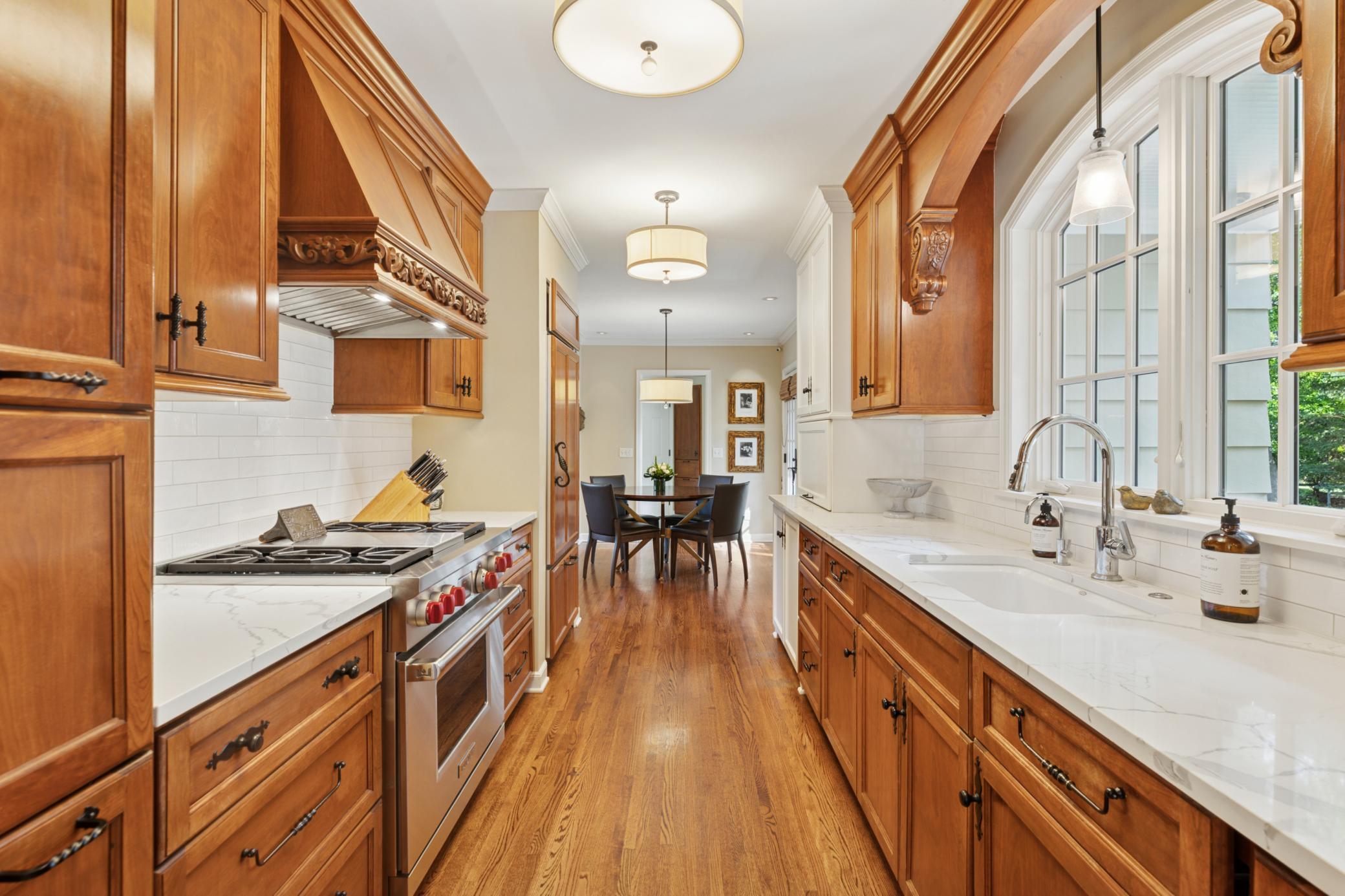 Sun-filled gourmet kitchen with high end appliances and informal dining