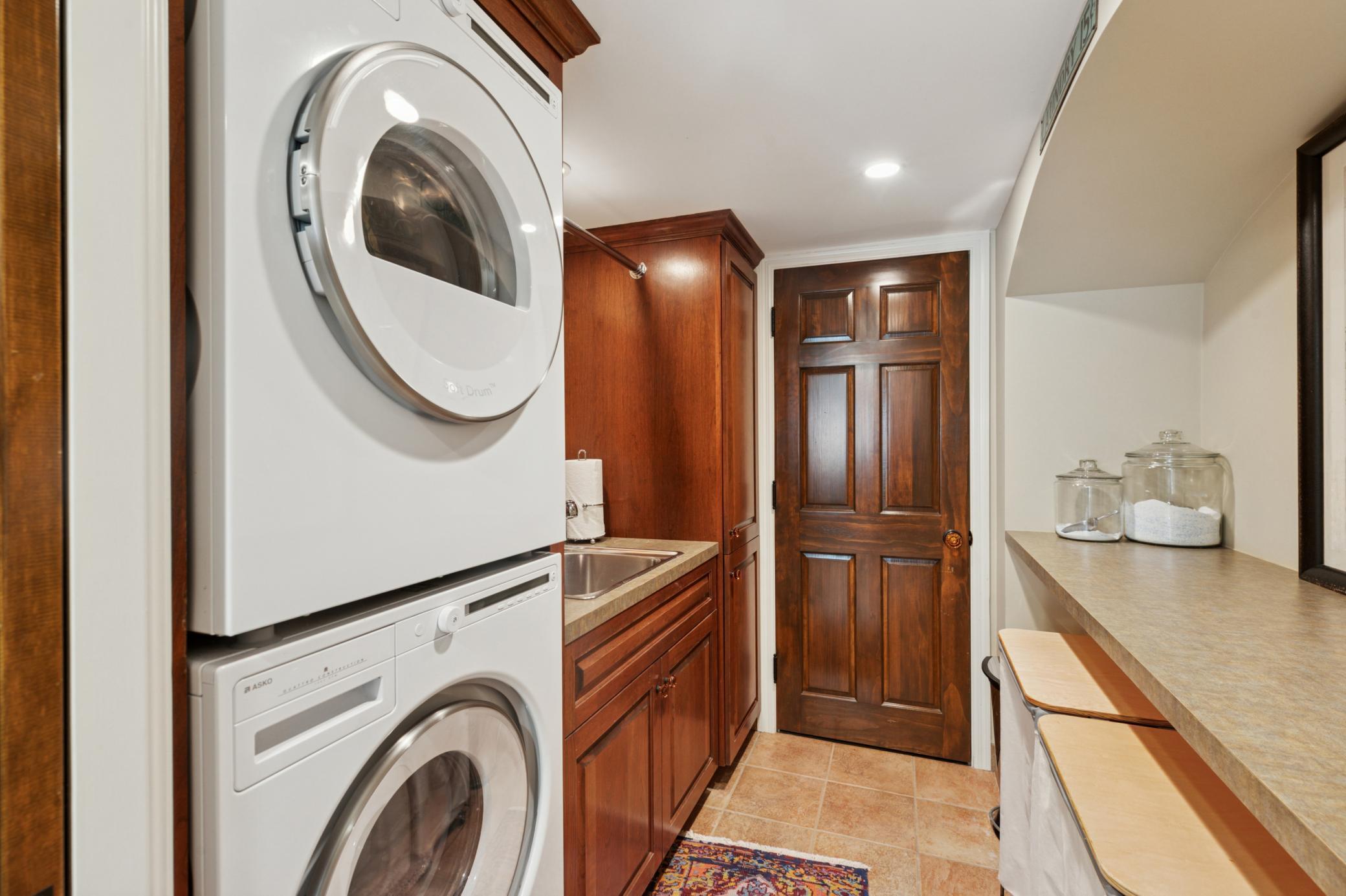 Laundry room with ample space to fold/hang and storage area.
