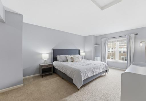Spacious primary bedroom with double closets and ensuite 3/4 bathroom.