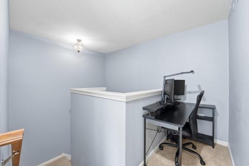 Great nook at the top of the stairs is being used as a home office.