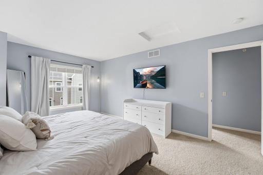 Spacious primary bedroom with double closets and ensuite 3/4 bathroom.