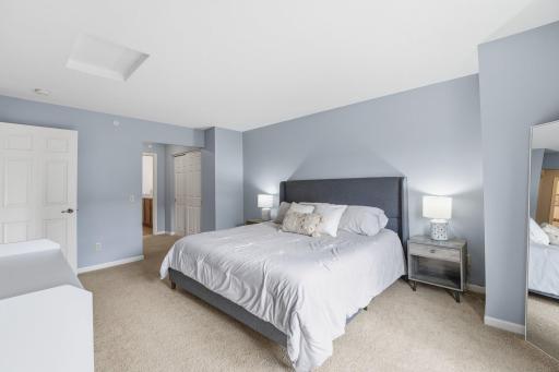 Spacious primary bedroom with double closets and ensuite 3/4 bathroom.