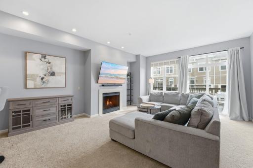 Open concept and light-filled, this living room is great for getting cozy or entertaining.