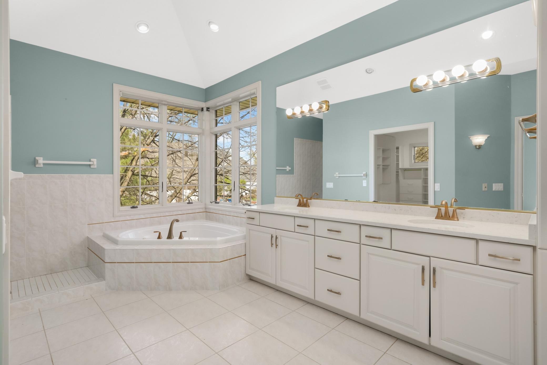 Spa-like primary bath with view of Lake Gervais