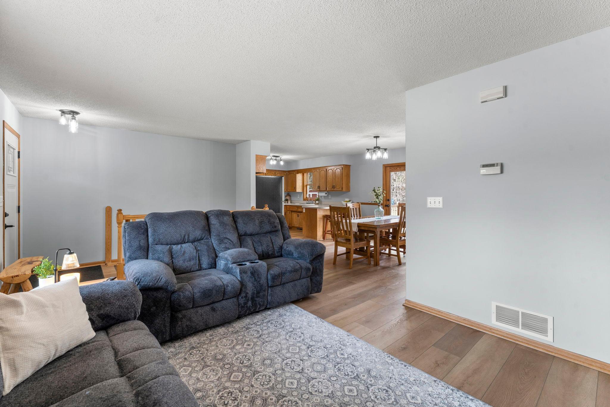 Luxury plank flooring extends throughout the main level, creating a warm and cohesive feel.