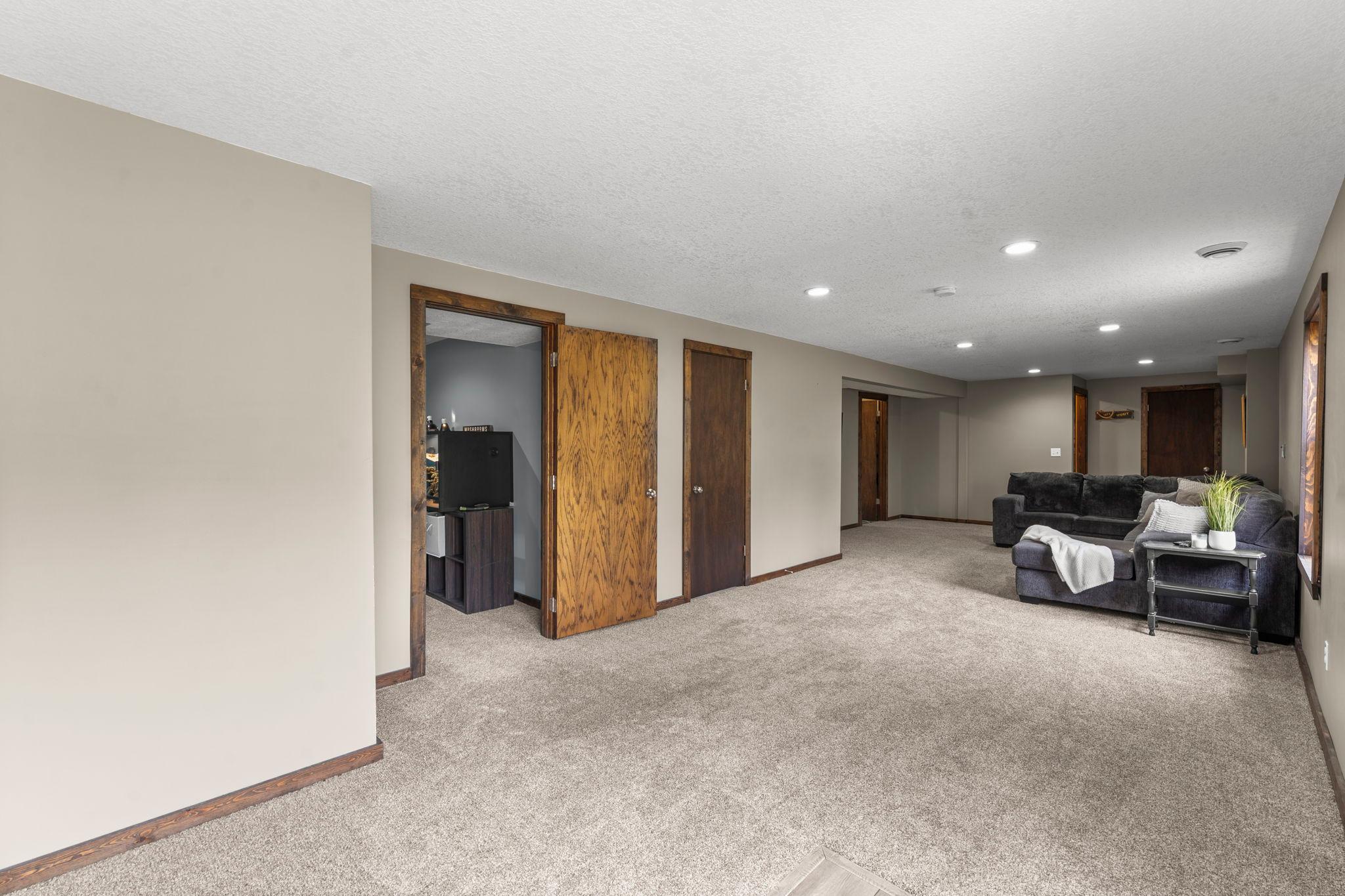 Another view of the lower-level family room showing the entrance to the home’s fourth bedroom.
