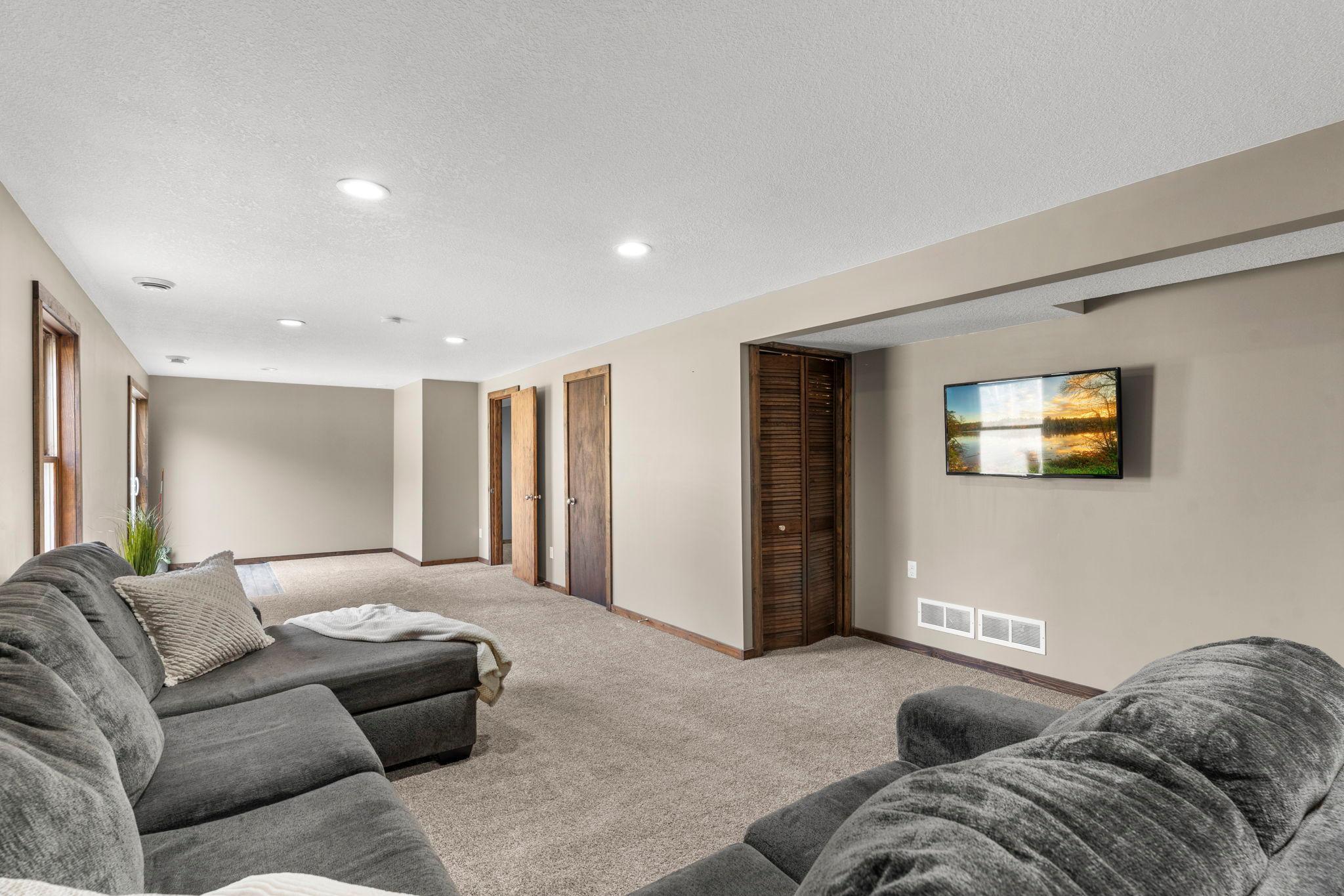 The lower level offers a spacious, carpeted family room with walkout access to the backyard.