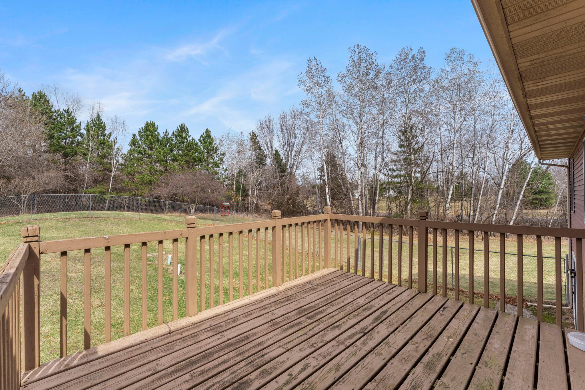 From the dining room, step out onto the deck overlooking the fully fenced backyard.