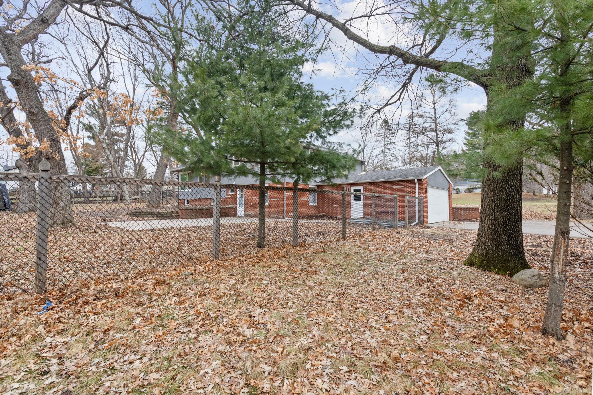 Side yard and fenced in backyard