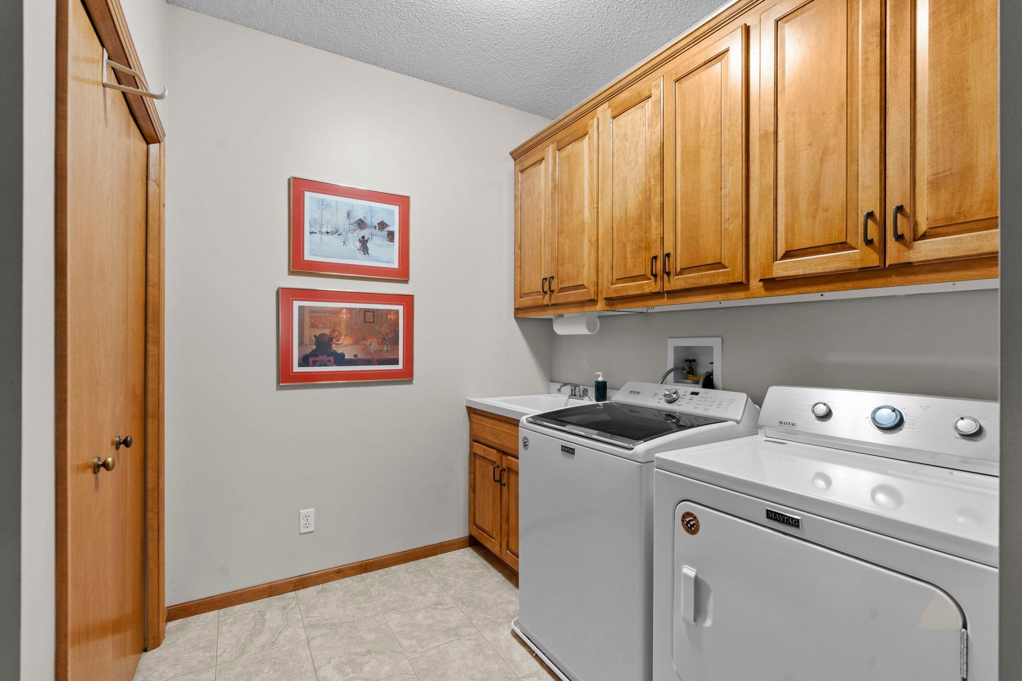 The main level is thoughtfully designed with an attached mudroom and laundry room just off the insulated 2-car garage. This space includes a new Maytag washer and dryer, along with generous cabinetry.