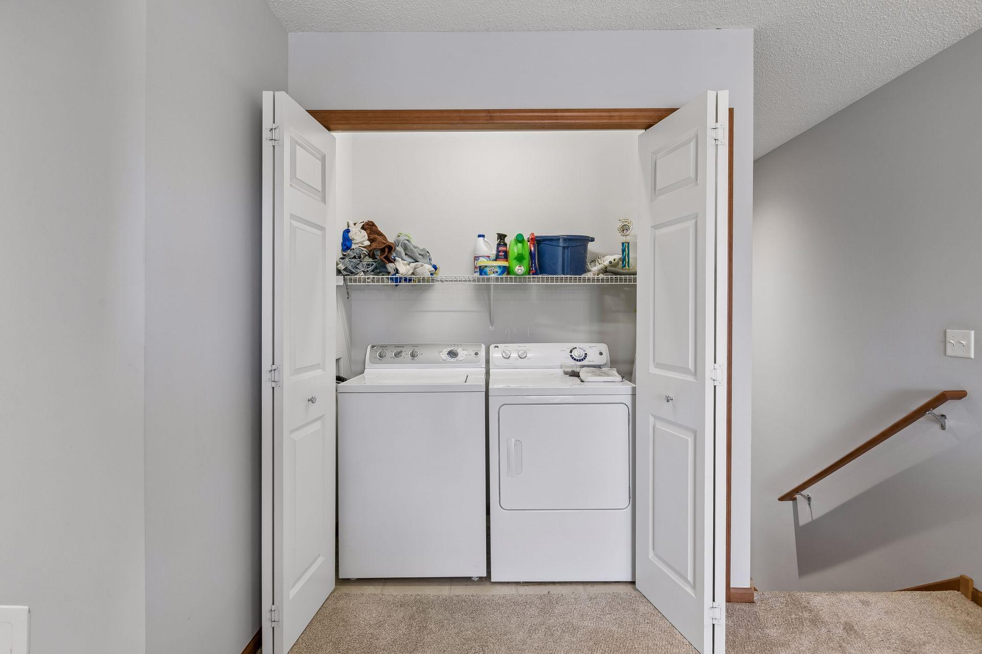 Conveniently located upper level laundry room with storage shelf.