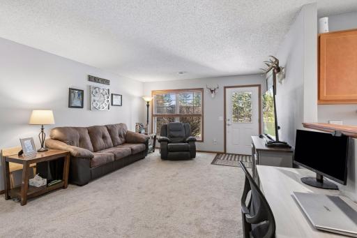 Large front window, and glass pane door let in loads of natural light.