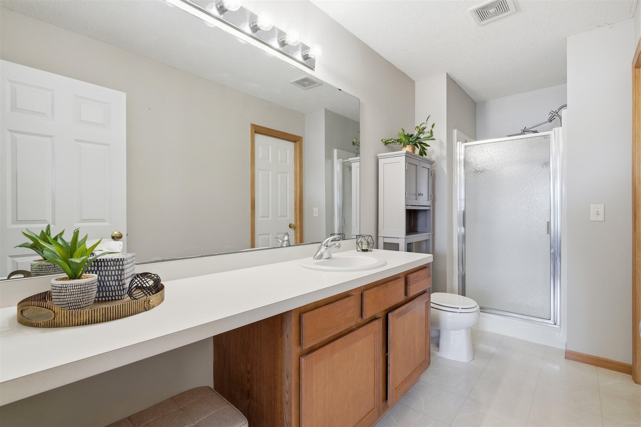 Expansive private primary bathroom complete with a dedicated vanity area with lots of counter space