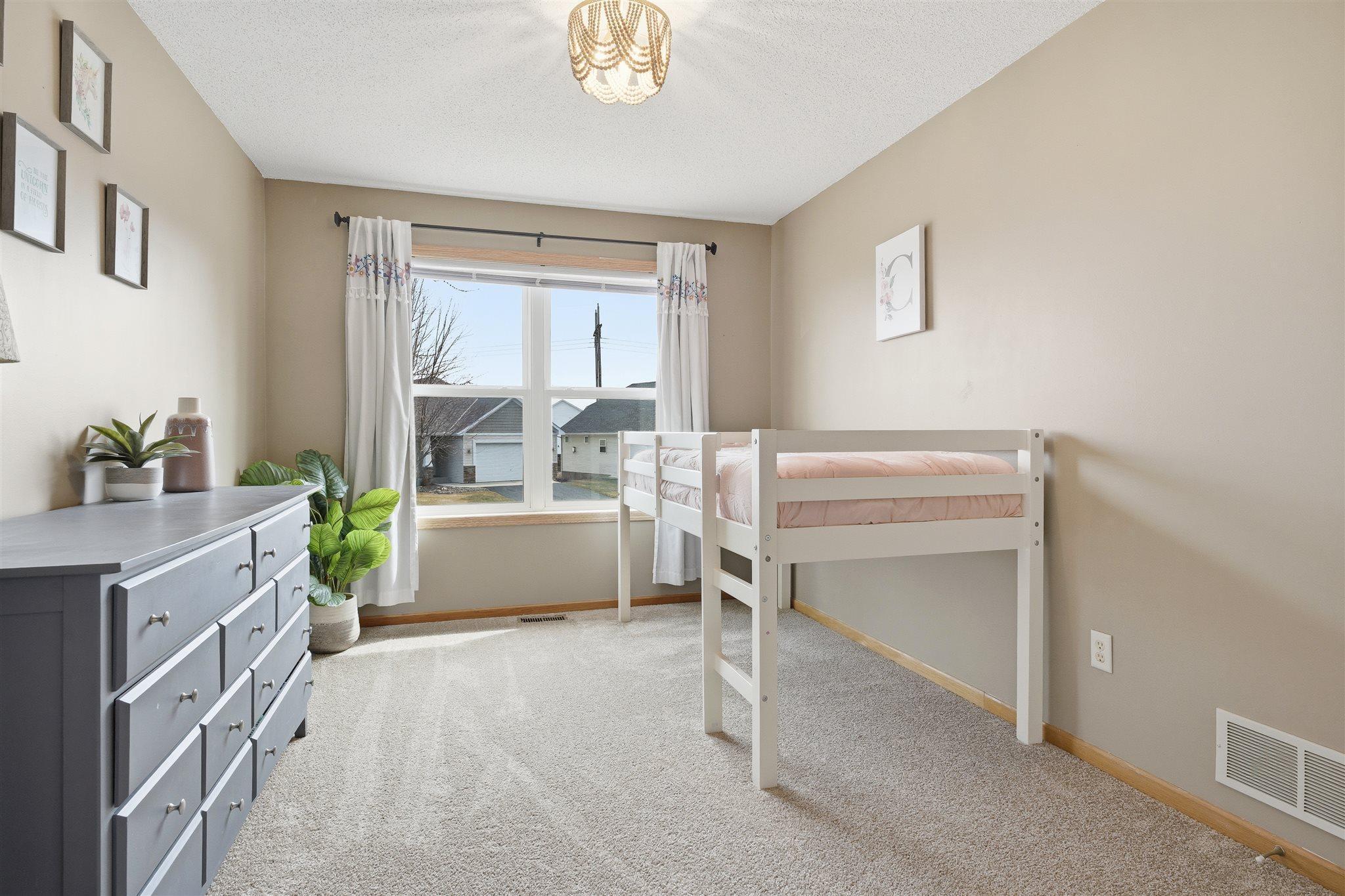 Upper-level third bedroom featuring fresh paint and abundant natural light!