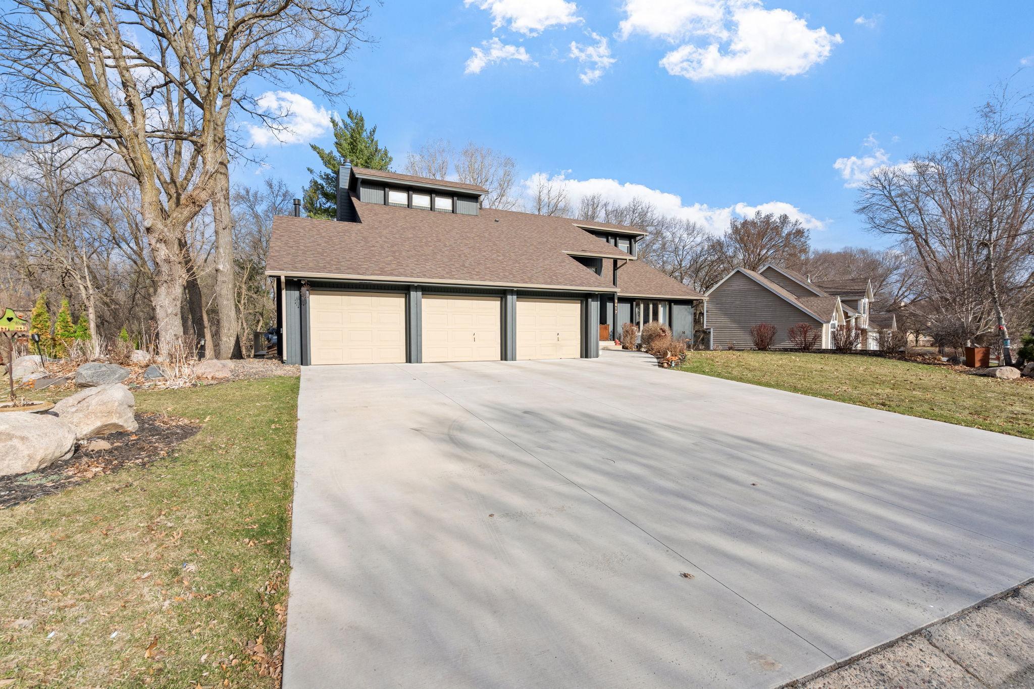 New concrete driveway and lower level patio in 2023. 3 car heated garage and worshop area .