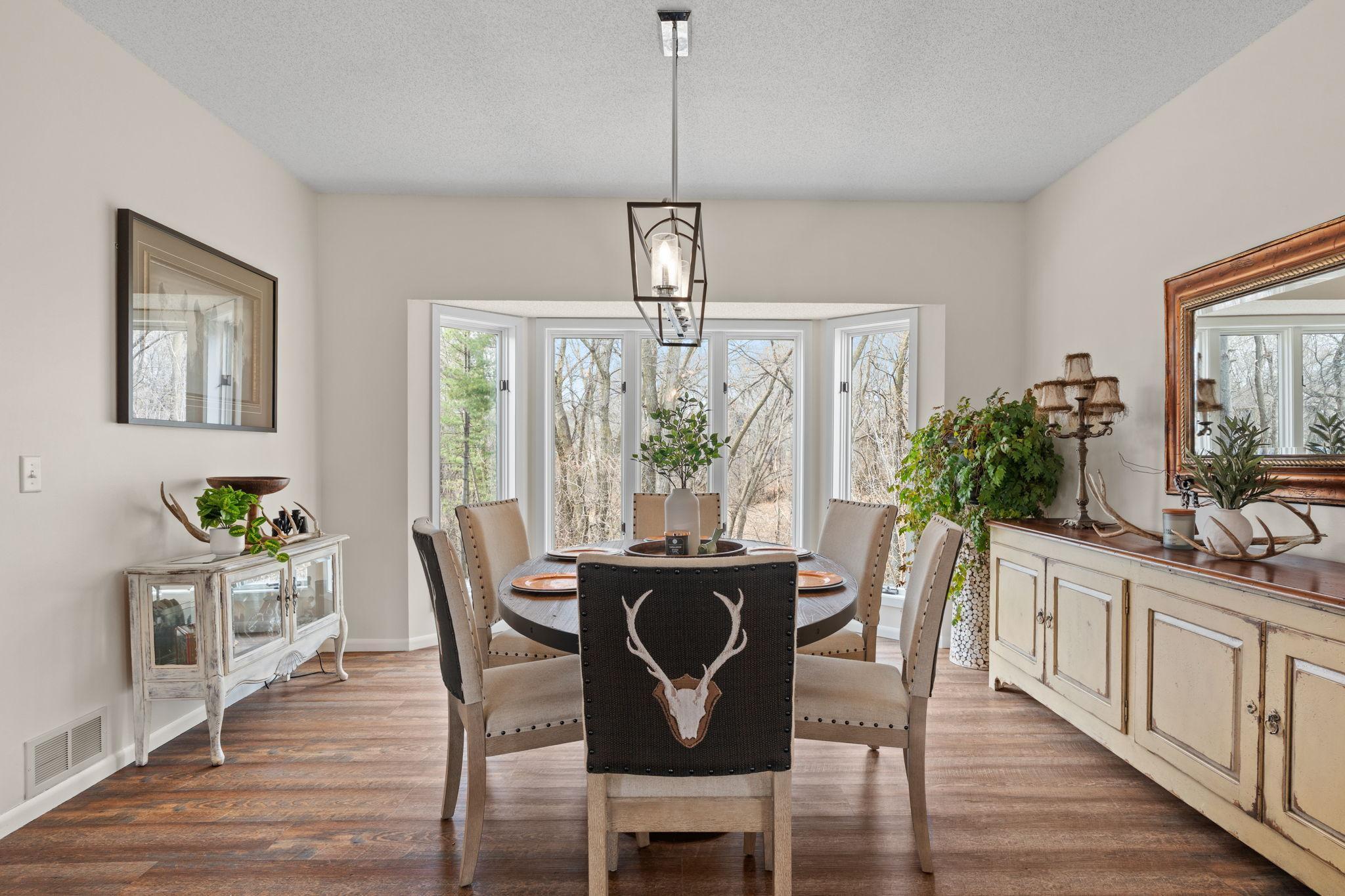 Large windows frame the nature in the backyard
