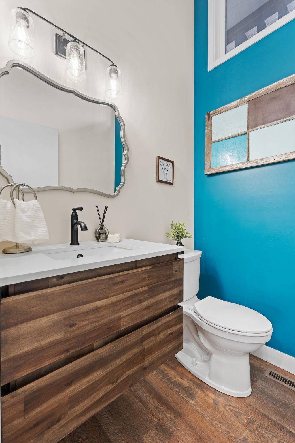 Main level 1/2 bathroom with new toilet, vanity and sink