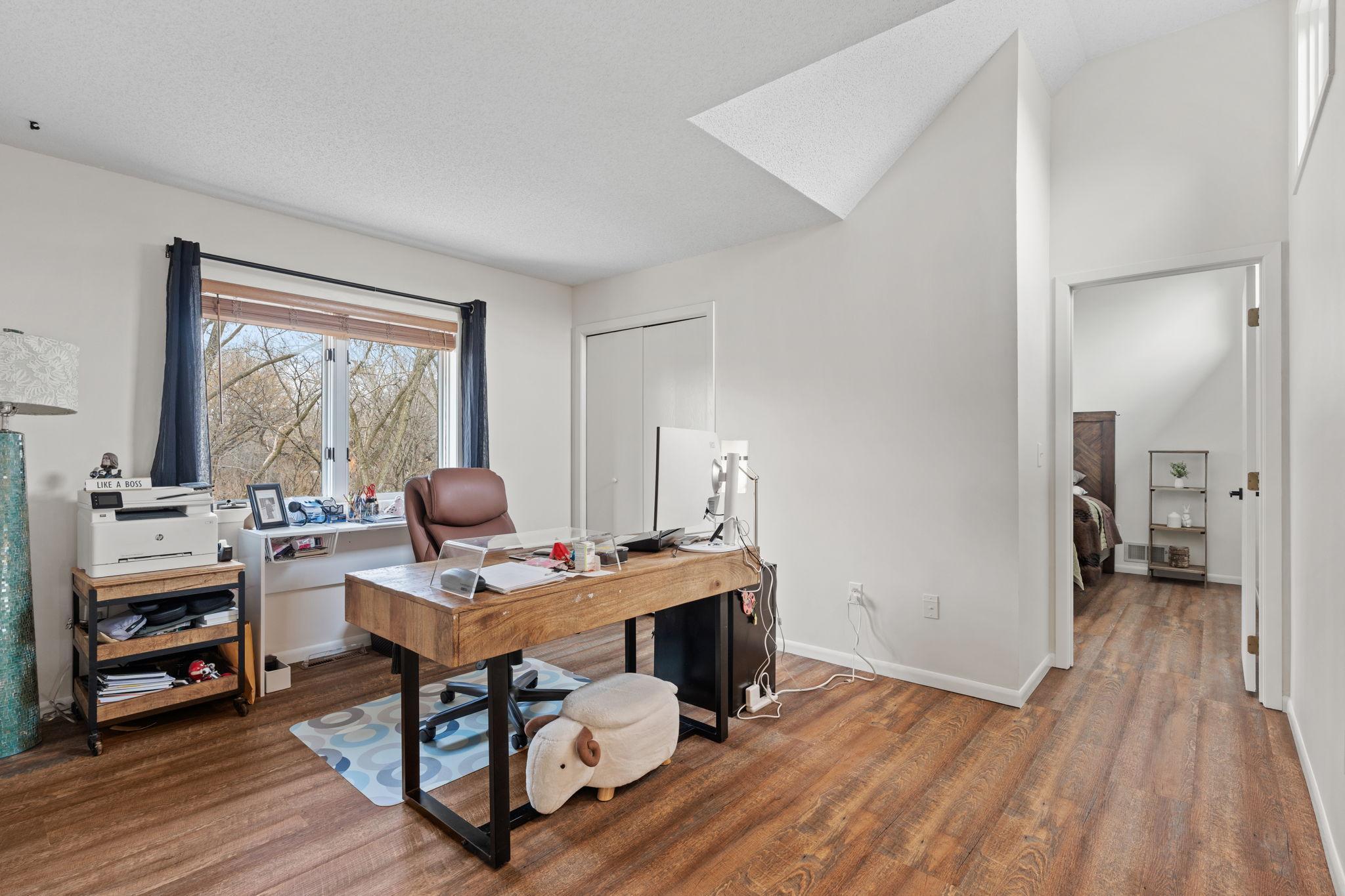 Upper level loft space that is currently used as an office. This space could easily become the 3rd upper level bedroom by adding a wall. The closet already exists !