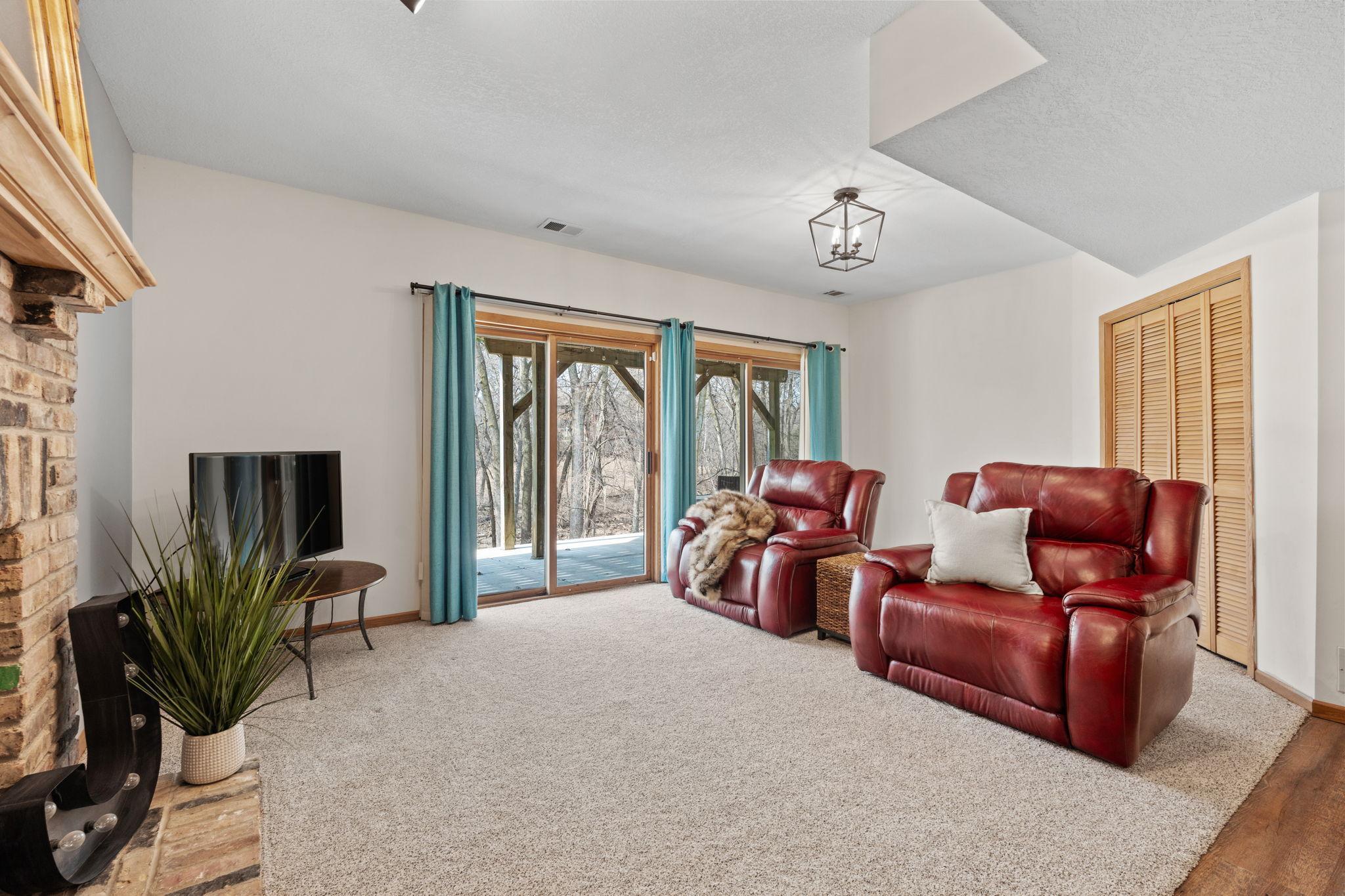 Family room area adjacent to the kitchen with 2 walk out double doors and new carpeting