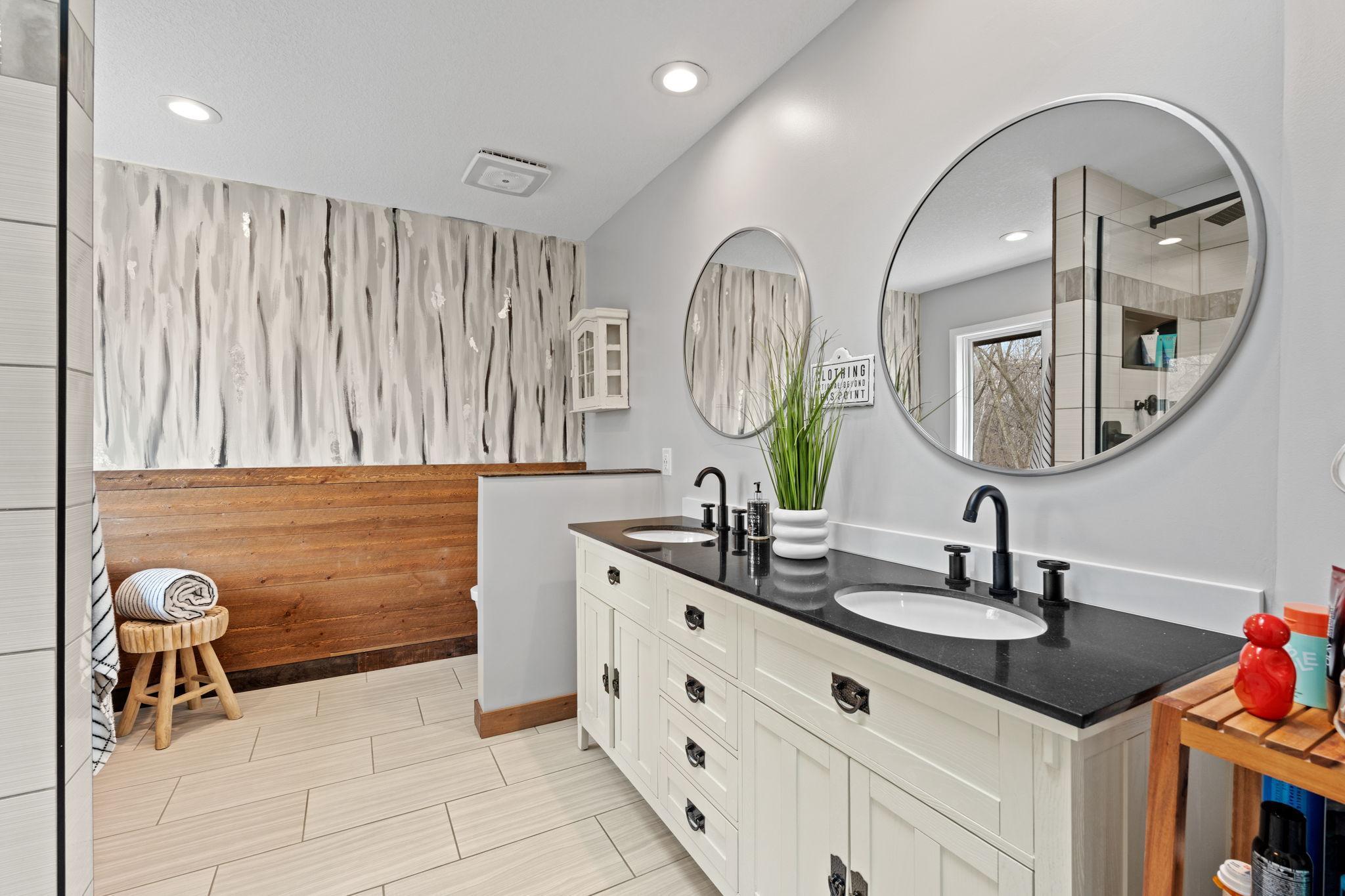 Primary Bath Remodel with heated floors, double vanity, granite countertops, new faucets and sinks and custom tilework