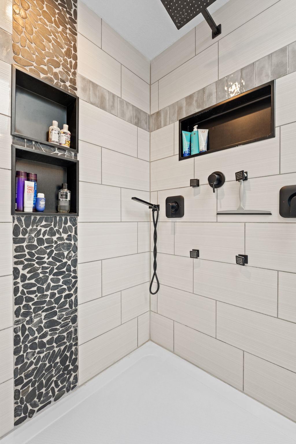 State of the art multiple water head shower with gorgeous tile and accents