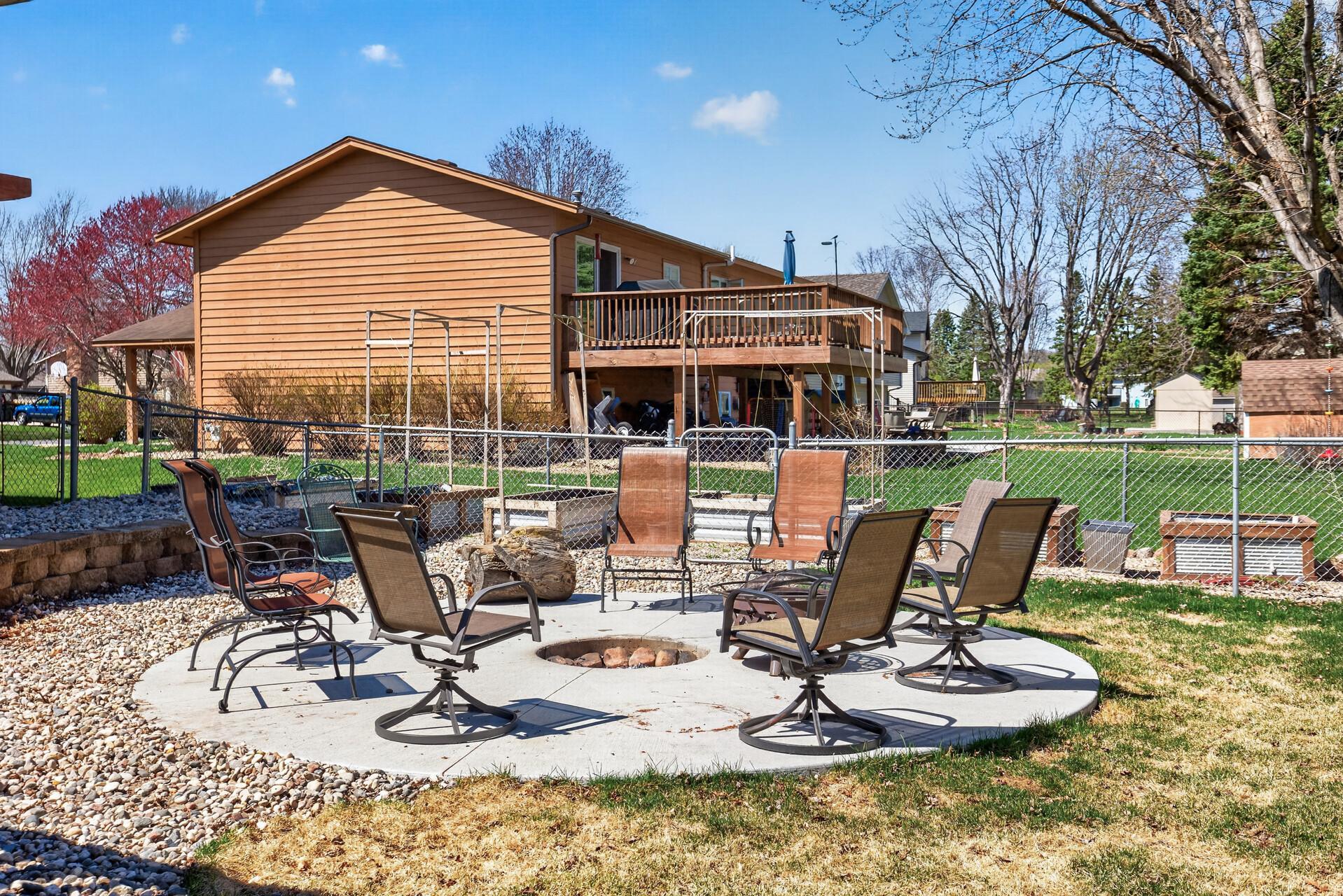 Concrete pad with a built-in firepit plus a separate fenced area for gardens