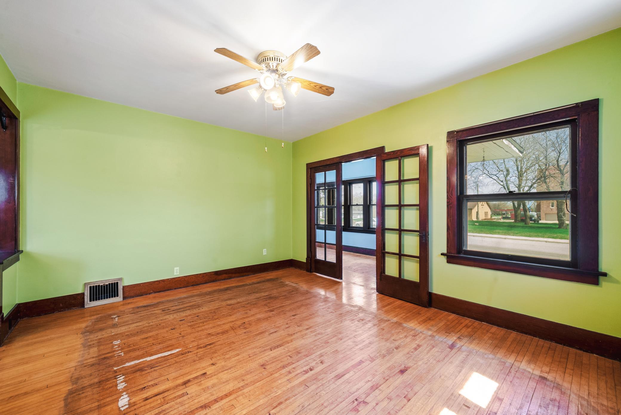 Spacious living and dining areas featuring hardwood floors, rich woodwork, and a classic built-in buffet. The home offers 9’ ceilings on the main level.