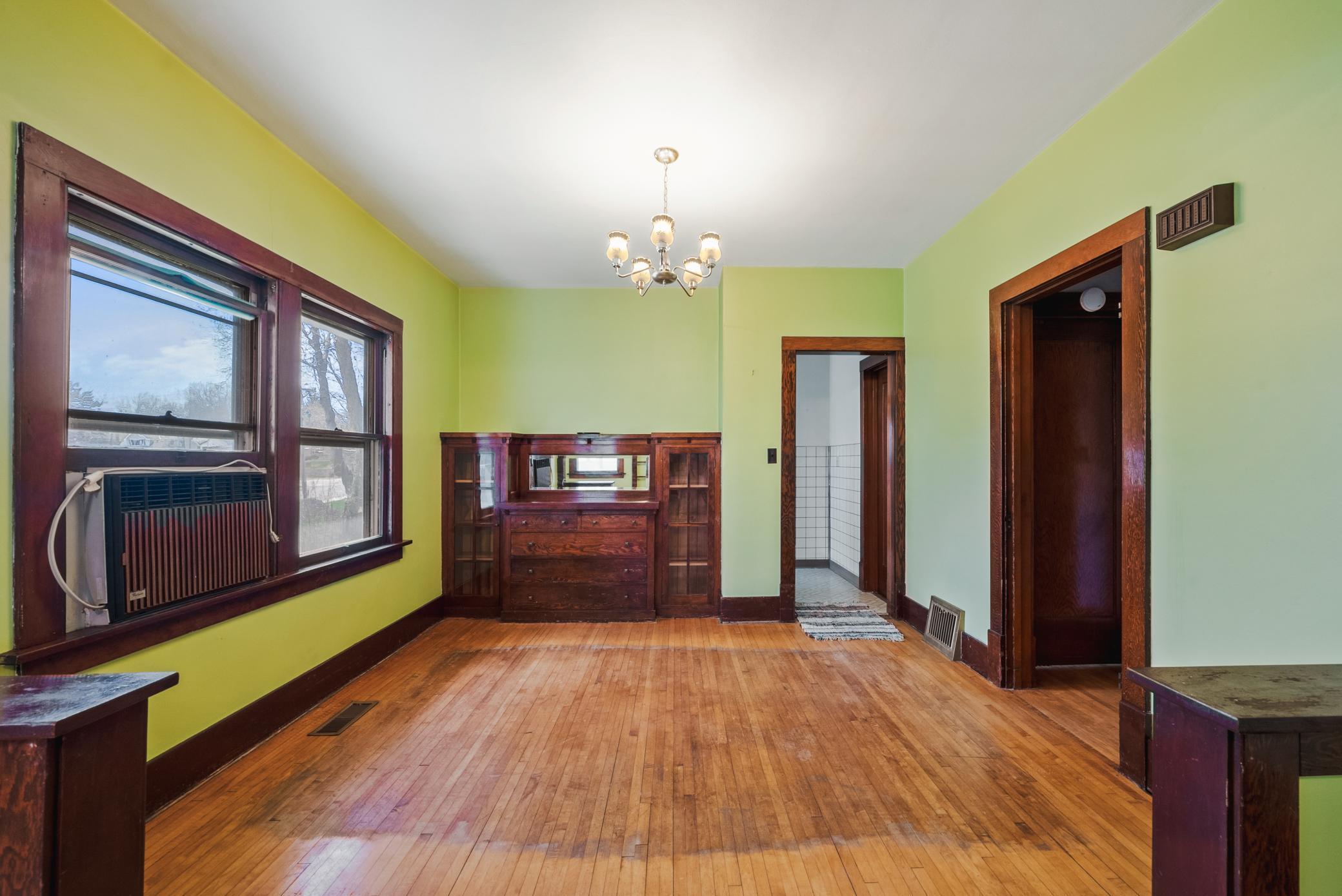 spacious living and dining areas featuring hardwood floors, rich woodwork, and a classic built-in buffet. The home offers 9’ ceilings on the main level.